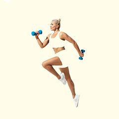 Image showing Young caucasian sportswoman isolated on studio background, modern artwork. Healthy lifestyle, movement, action, motion, advertising and sports concept. Abstract design.