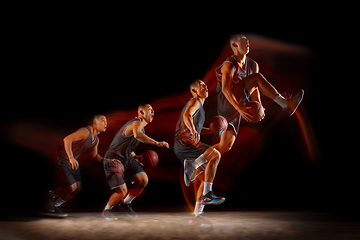 Image showing Young east asian basketball player in action and jump in mixed strobe light over dark studio background. Concept of sport, movement, energy and dynamic, healthy lifestyle.