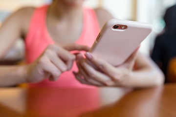 Image showing Sport woman use of mobile phone