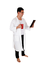 Image showing Tall man standing in bathrobe and coffee mug