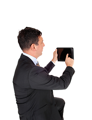 Image showing Business man looking at his tablet PS