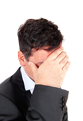 Image showing Business man covering is face he is depressed
