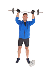 Image showing Tall man lifting the weight over his head