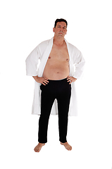 Image showing Shirtless man in white bathrobe