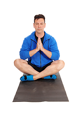 Image showing Handsome man sitting on floor doing yoga