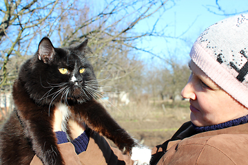 Image showing woman looking at black cat