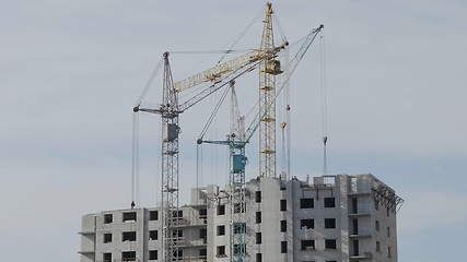 Image showing Many of cranes. Tower cranes against blue sky, with clouds