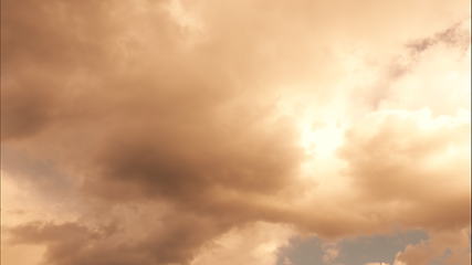 Image showing Time lapse Fluffy clouds float across the blue sky.