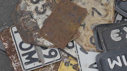 Image showing Old rusty license plates of cars.