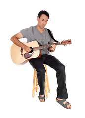 Image showing Young casual man playing the guitar