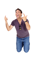 Image showing Screaming young man kneeling on floor