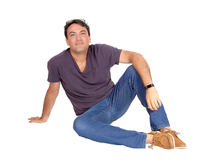 Image showing A handsome tall man siting on the floor