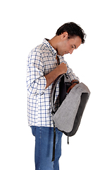 Image showing Young tall man looking into his backpack