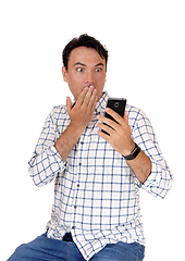 Image showing Man is surprised what he see's on his phone