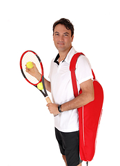 Image showing Man standing with his tennis tools, smiling