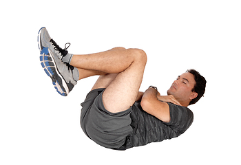 Image showing Man doing sit-ups on the floor