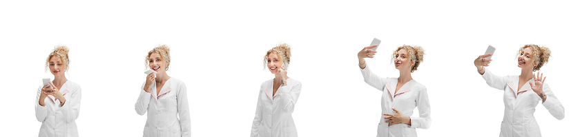 Image showing Portrait of female doctor in white uniform using phone isolated over white background