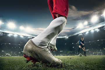 Image showing Close-up leg football or soccer player at stadium in flashlights - motion, action, activity concept. Flyer for ad, design.