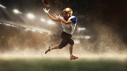 Image showing Young man american football player at stadium in motion. Action, activity, sportlife concept. Flyer for ad, design.