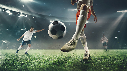 Image showing Close-up football or soccer players at stadium - motion, action, activity concept. Flyer for ad, design.