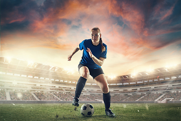 Image showing Female football or soccer player at stadium - motion, action, activity concept. Flyer for ad, design.