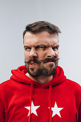 Image showing Young man with dual emotions combination on face isolated on white background, emotional and expressive