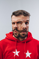 Image showing Young man with dual emotions combination on face isolated on white background, emotional and expressive