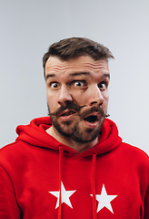 Image showing Young man with dual emotions combination on face isolated on white background, emotional and expressive