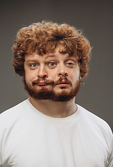 Image showing Young man with dual emotions combination on face isolated on dark background, emotional and expressive