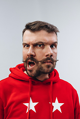 Image showing Young man with dual emotions combination on face isolated on white background, emotional and expressive