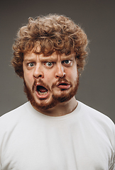 Image showing Young man with dual emotions combination on face isolated on dark background, emotional and expressive