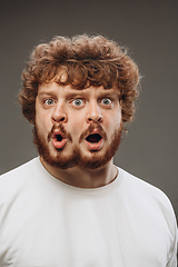 Image showing Young man with dual emotions combination on face isolated on dark background, emotional and expressive