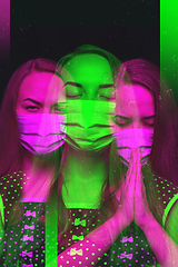 Image showing Close up portrait of caucasian woman wearing face mask on studio background. Modern and trendy duotone effect, double exposure