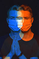 Image showing Close up portrait of caucasian man wearing face mask background. Modern and trendy duotone effect, double exposure