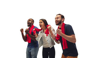 Image showing Multiethnic soccer fans cheering for favourite sport team with bright emotions isolated on white studio background