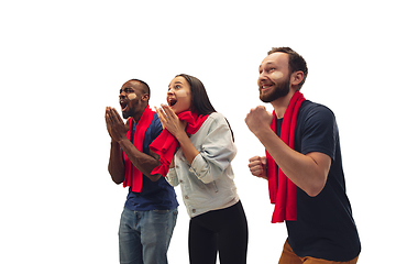 Image showing Multiethnic soccer fans cheering for favourite sport team with bright emotions isolated on white studio background