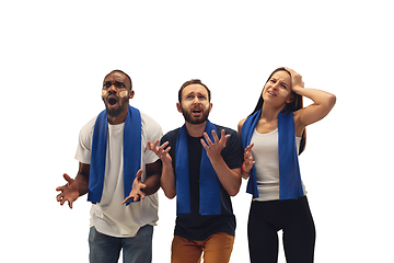 Image showing Multiethnic soccer fans cheering for favourite sport team with bright emotions isolated on white studio background