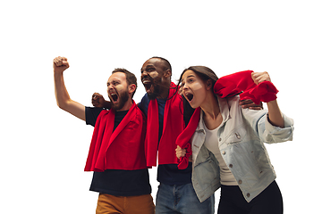 Image showing Multiethnic soccer fans cheering for favourite sport team with bright emotions isolated on white studio background