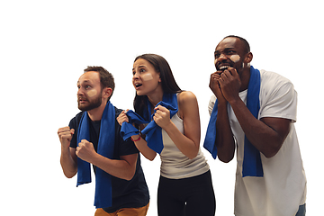 Image showing Multiethnic soccer fans cheering for favourite sport team with bright emotions isolated on white studio background