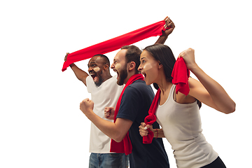 Image showing Multiethnic soccer fans cheering for favourite sport team with bright emotions isolated on white studio background