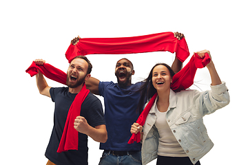 Image showing Multiethnic soccer fans cheering for favourite sport team with bright emotions isolated on white studio background