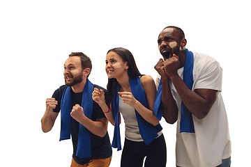 Image showing Multiethnic soccer fans cheering for favourite sport team with bright emotions isolated on white studio background