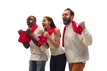 Image showing Multiethnic soccer fans cheering for favourite sport team with bright emotions isolated on white studio background