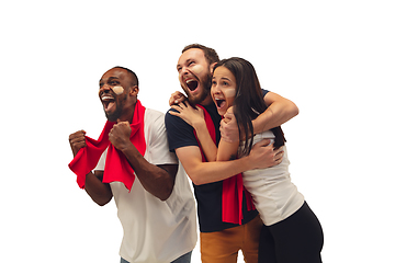 Image showing Multiethnic soccer fans cheering for favourite sport team with bright emotions isolated on white studio background