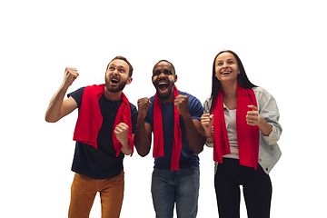 Image showing Multiethnic soccer fans cheering for favourite sport team with bright emotions isolated on white studio background