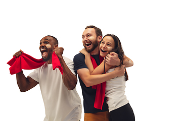 Image showing Multiethnic soccer fans cheering for favourite sport team with bright emotions isolated on white studio background