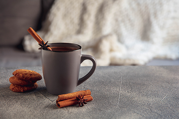 Image showing Closeup cup of tea or coffee with cinnamon isolated on grey and white background. Copy Space for ad, design.