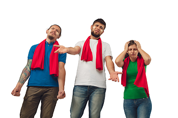 Image showing Two men and woman as soccer fans cheering for favourite sport team with bright emotions isolated on white studio background