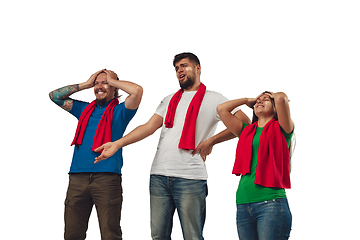 Image showing Two men and woman as soccer fans cheering for favourite sport team with bright emotions isolated on white studio background