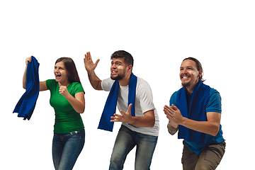 Image showing Two men and woman as soccer fans cheering for favourite sport team with bright emotions isolated on white studio background